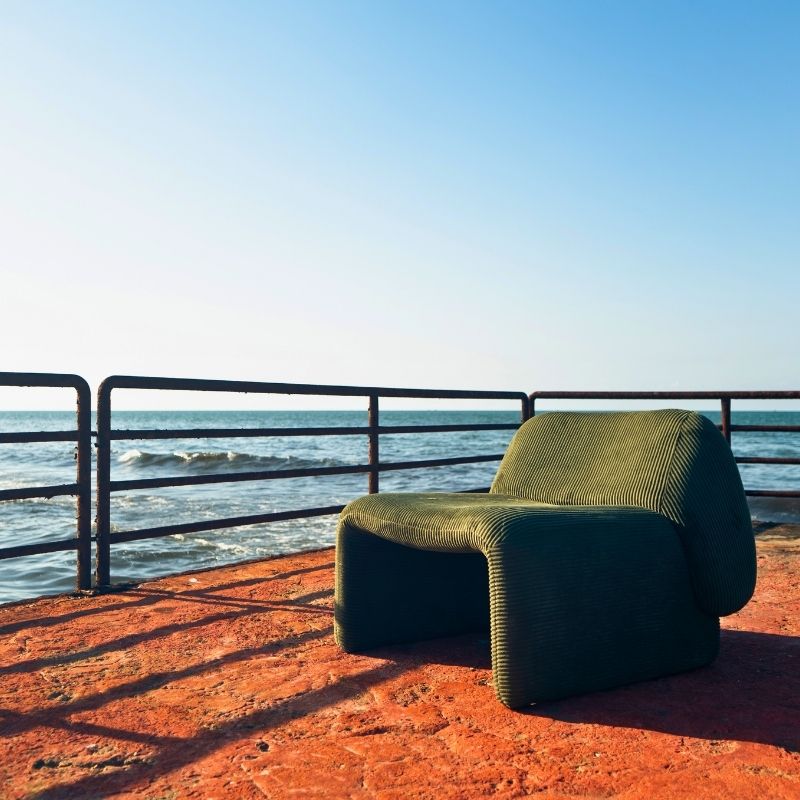 Olive green corduroy modular armchair with ribbed fabric texture on a terrace overlooking the sea Mahogni