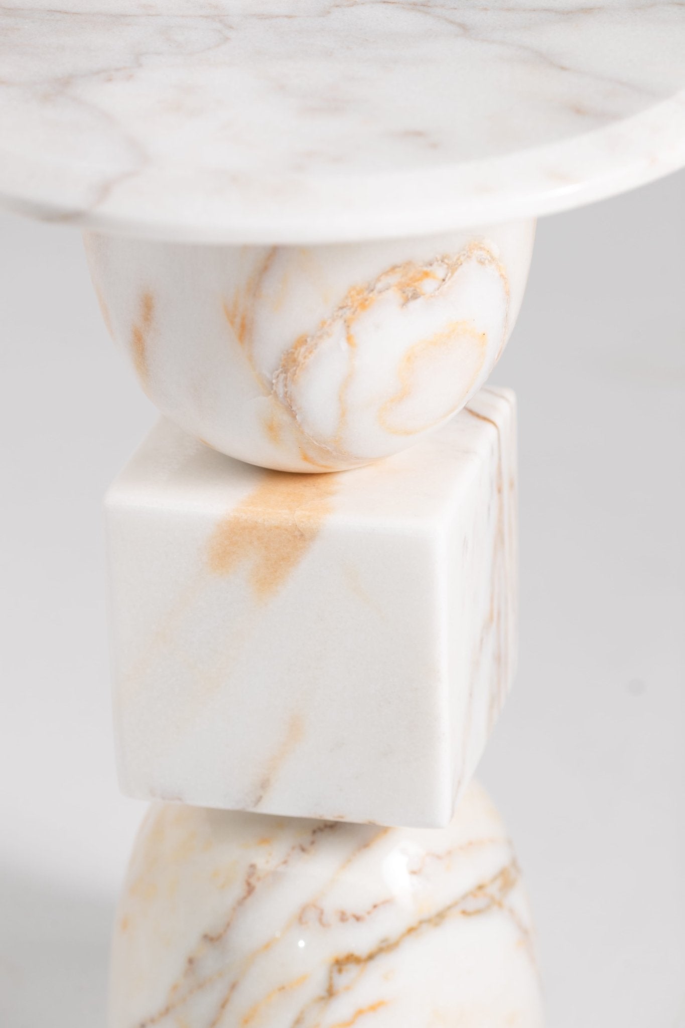 Vanta white marble side table with gold veining and stacked geometric shapes