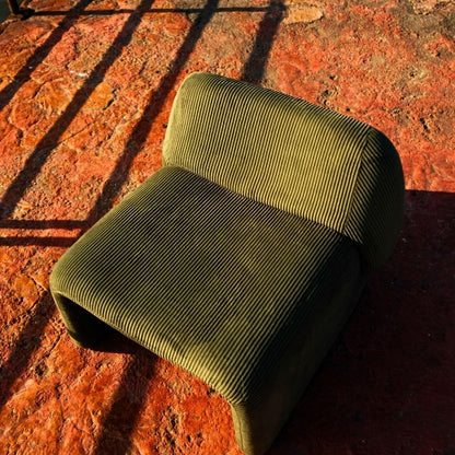 Olive green corduroy modular armchair with ribbed fabric texture on a terrace overlooking the sea Mahogni