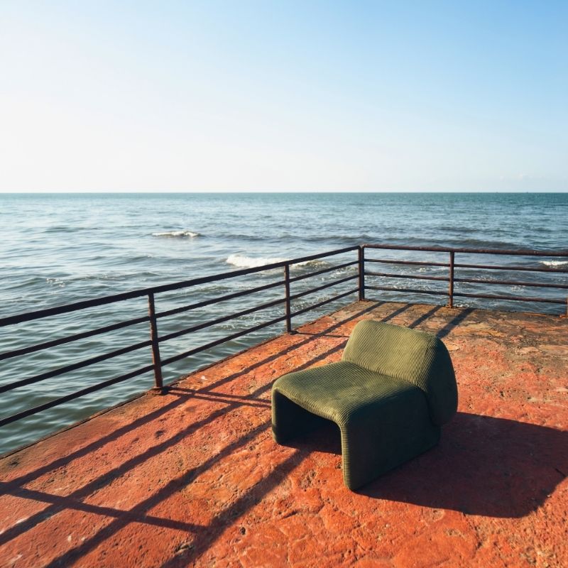 Olive green corduroy modular armchair with ribbed fabric texture on a terrace overlooking the sea Mahogni