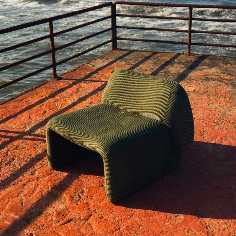 Olive green corduroy modular armchair with ribbed fabric texture on a terrace overlooking the sea Mahogni