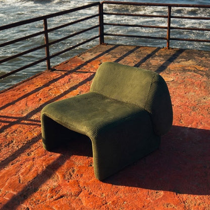 Olive green corduroy modular armchair with ribbed fabric texture on a terrace overlooking the sea Mahogni