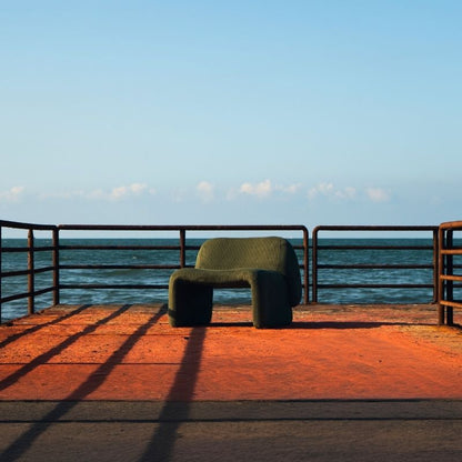 Olive green corduroy modular armchair with ribbed fabric texture on a terrace overlooking the sea Mahogni