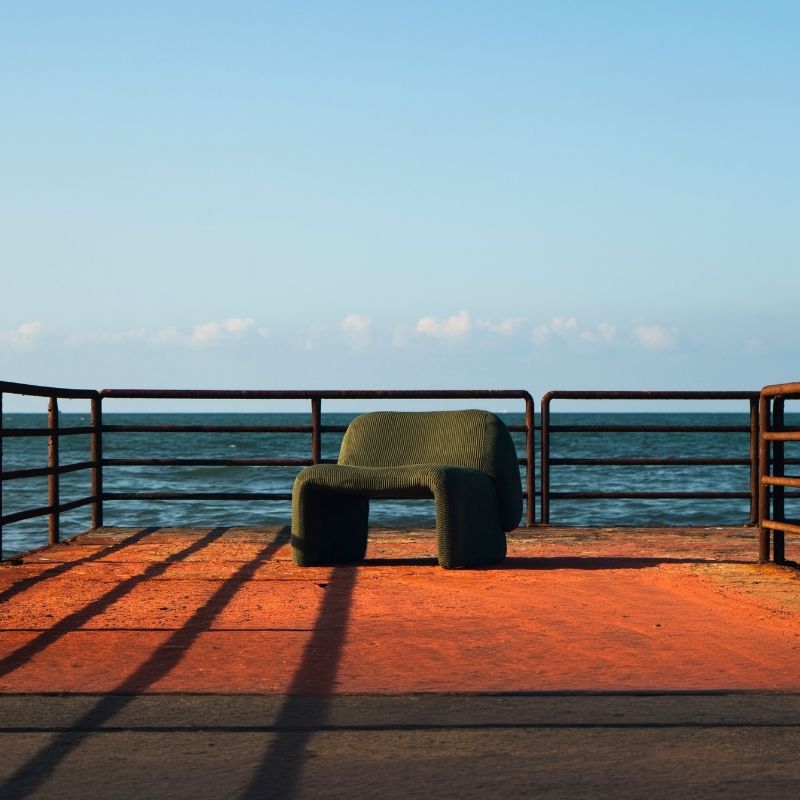 Olive green corduroy modular armchair with ribbed fabric texture on a terrace overlooking the sea Mahogni