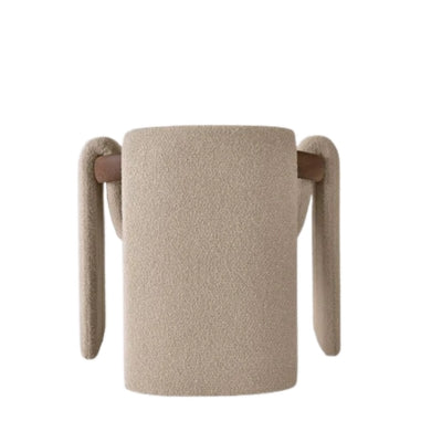 Modern sculptural fabric armchair with minimalist wooden frame design for contemporary living rooms.