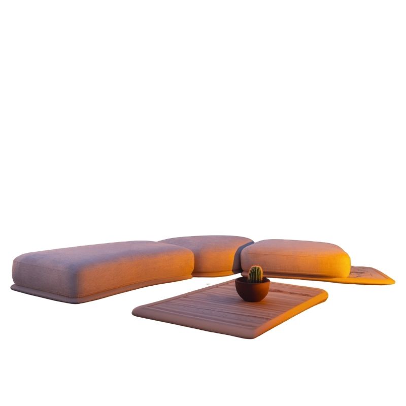 Minimalist cream floor seating set with organic rounded ottomans on sand at sunset.