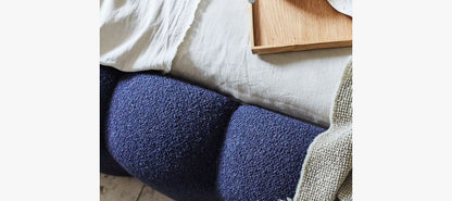 Close-up Details of Luna Bed Quilted Bouclé Headboard and Warm Pillows