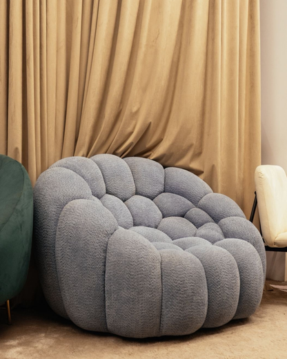 Grey bubble lounge chair with cloud-like tufted design for modern living room decor by Mahogni.