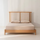 Minimalist solid oak bed frame featuring a split twin cushion upholstered headboard in beige fabric by Mahogni.