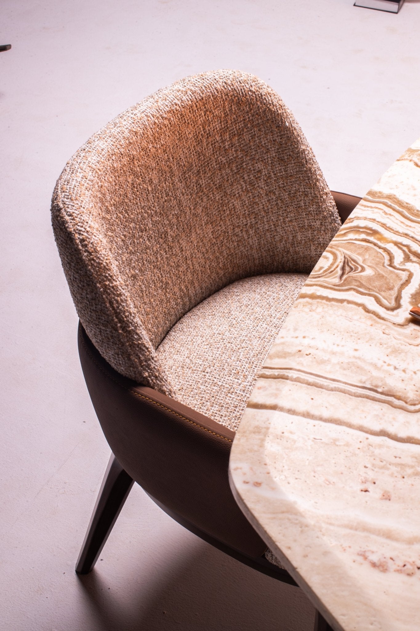 Modern Light Dining Room set with oval marble table, sculptural pedestal bases, and textured chairs by Mahogni.