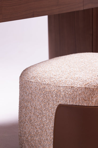 High-end luxury bedroom set featuring a tall upholstered bed with vertical tufting, dark wood nightstands, and a modern vanity by Mahogni.